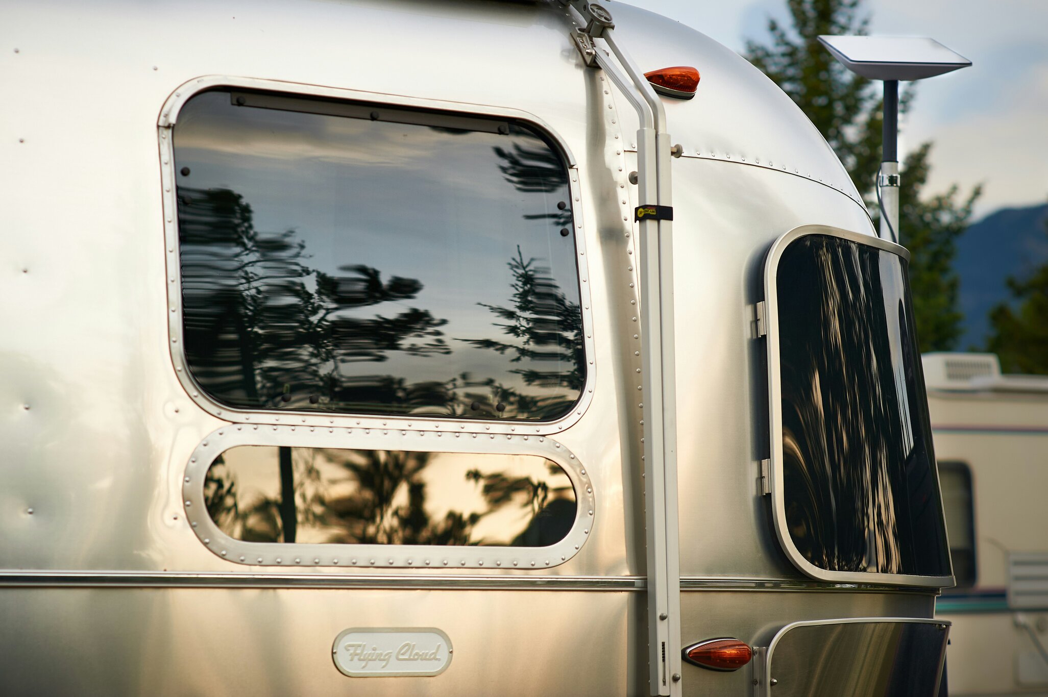 Recreational vehicle with satellite internet equipment in an outdoor setting